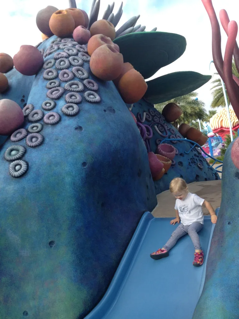 Little girl playing on the resort playground