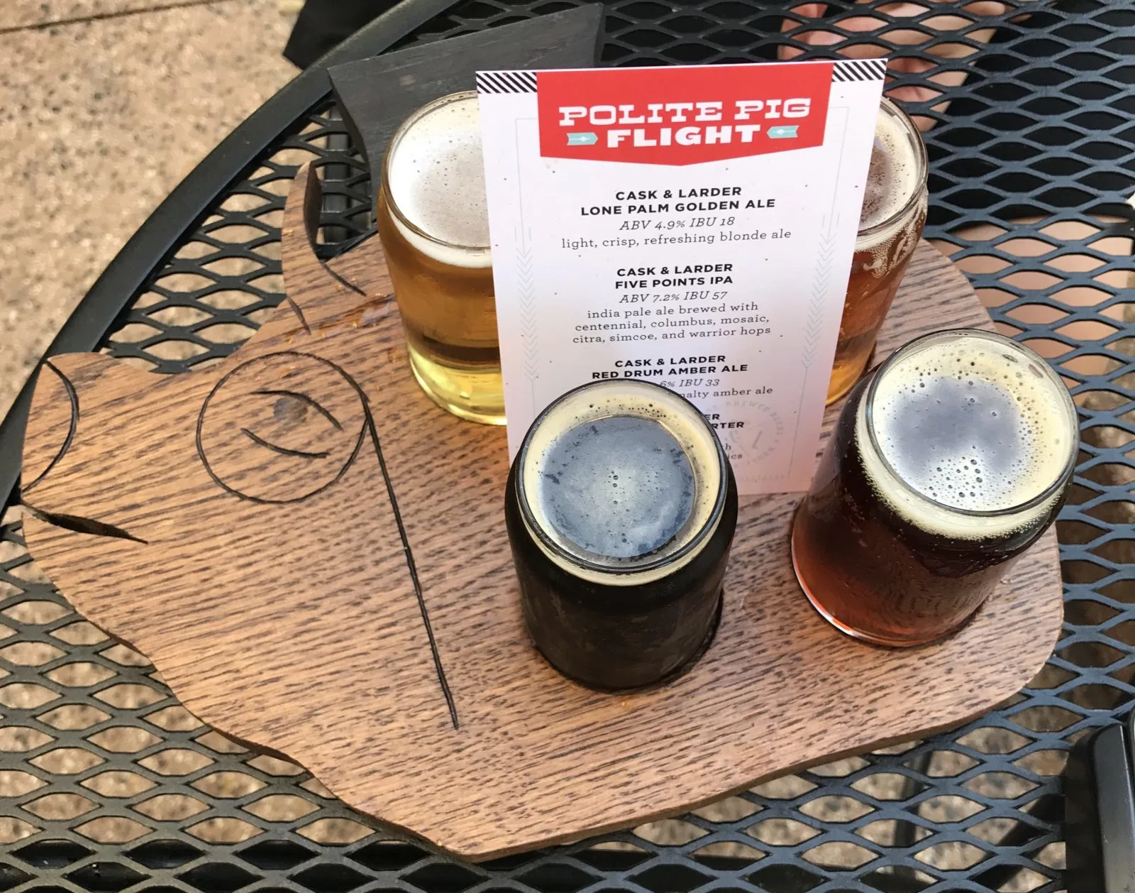 Beer Flight served on a wood platter in the shape of a pig head