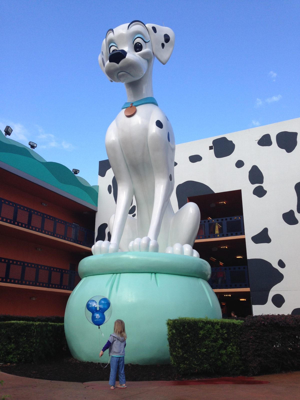 girl standing in front of dalmatian statue at all-star movies resort 