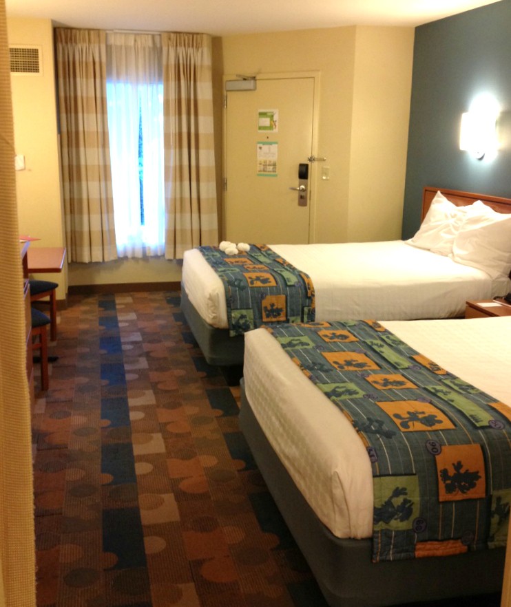 two beds and sitting area in Disney's Pop Century Resort Room
