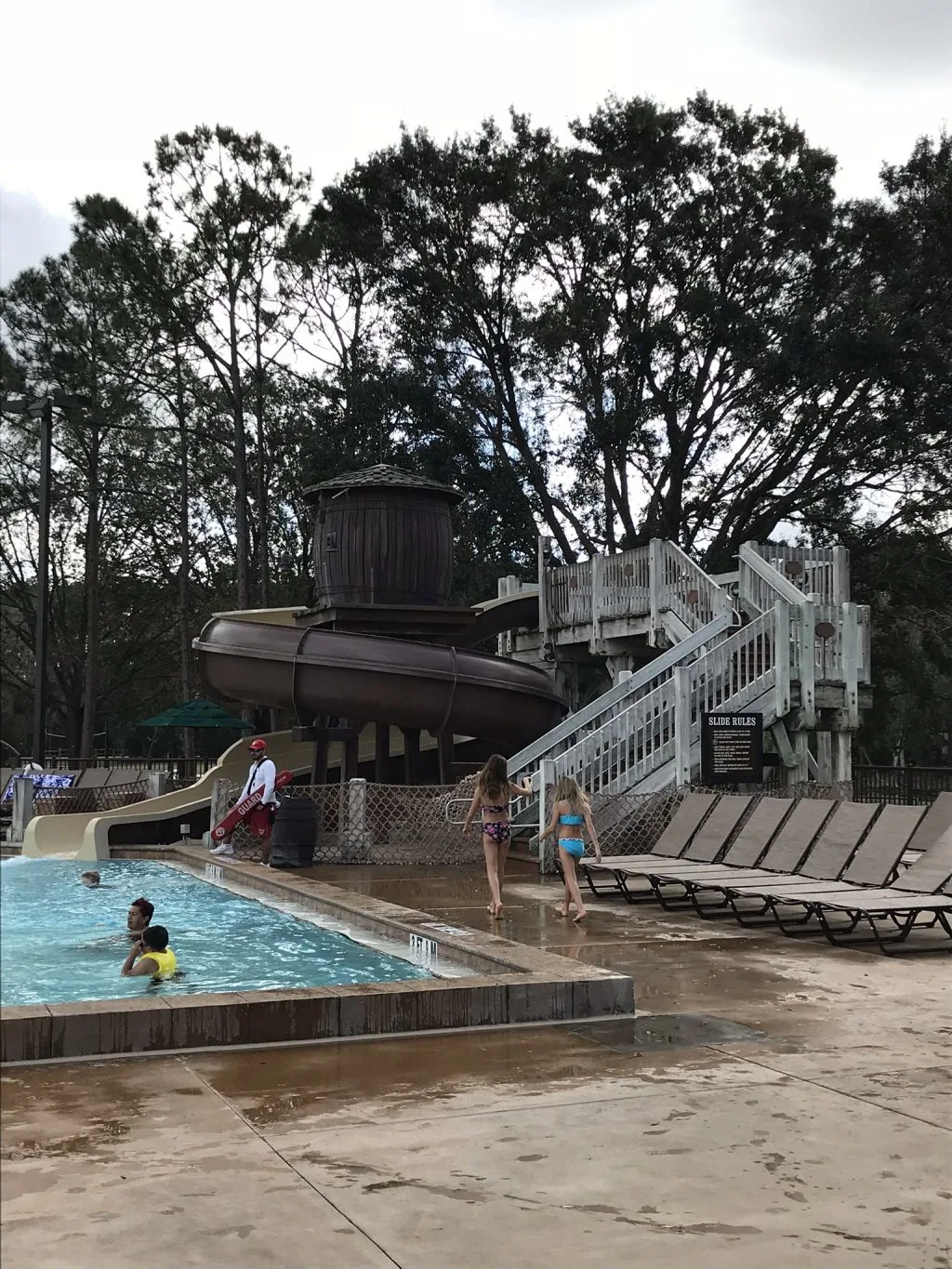 people enjoying the pool and large water slide at Fort Wilderness Campground