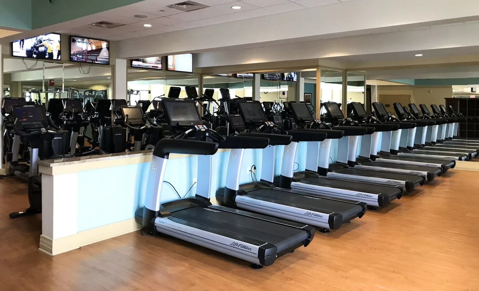 resort fitness center with cardio machines and televisions