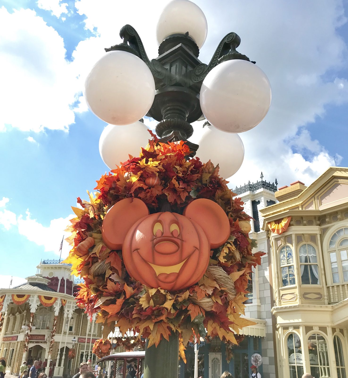 lamp on main street with a fall leaf wreath and mickey mouse pumpkin