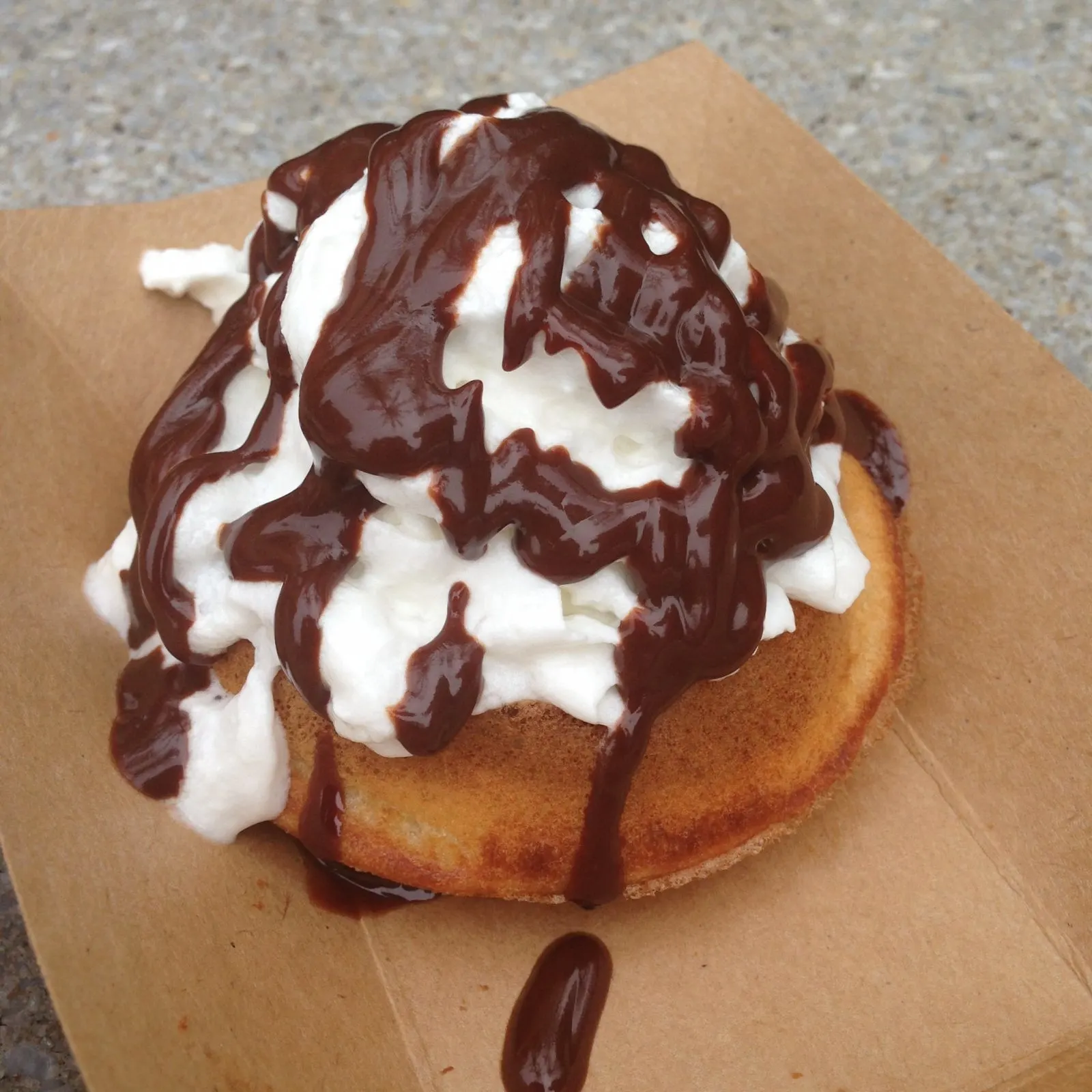 Belgian waffle covered in whipped cream and chocolate from epcot food and wine festival