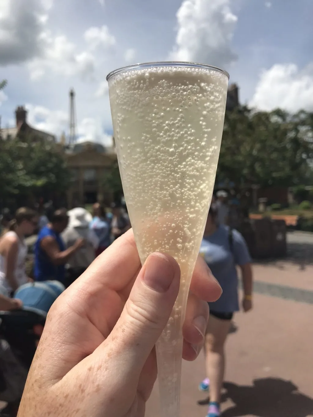 bubbly adult beverage with people in the background