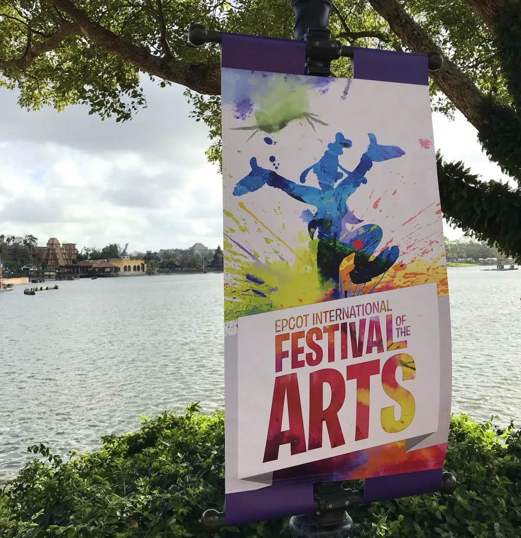 Epcot International Festival of the Arts sign with waterway in the background