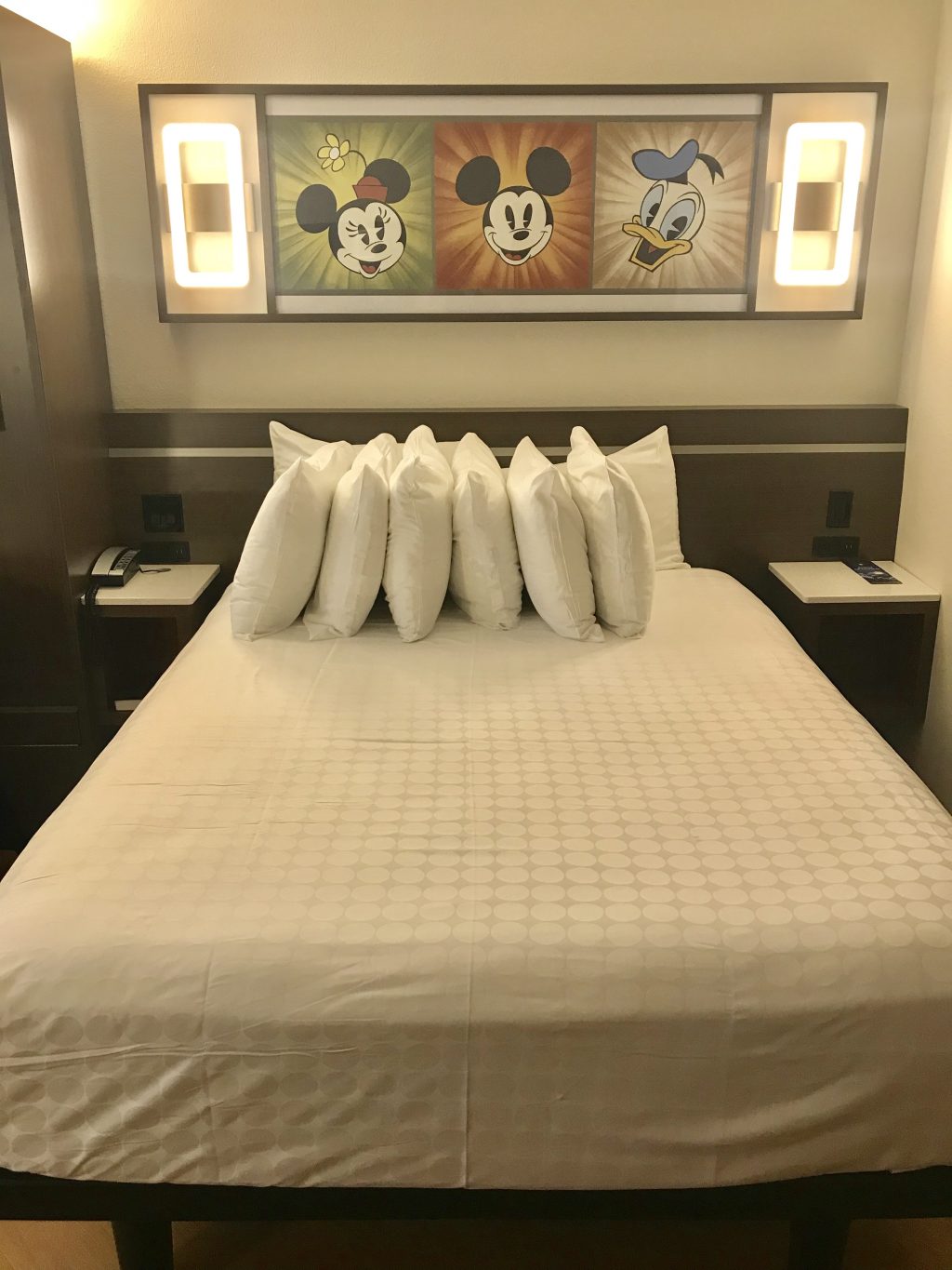 Bed and lighting in an All Star Movies Resort refurbished room