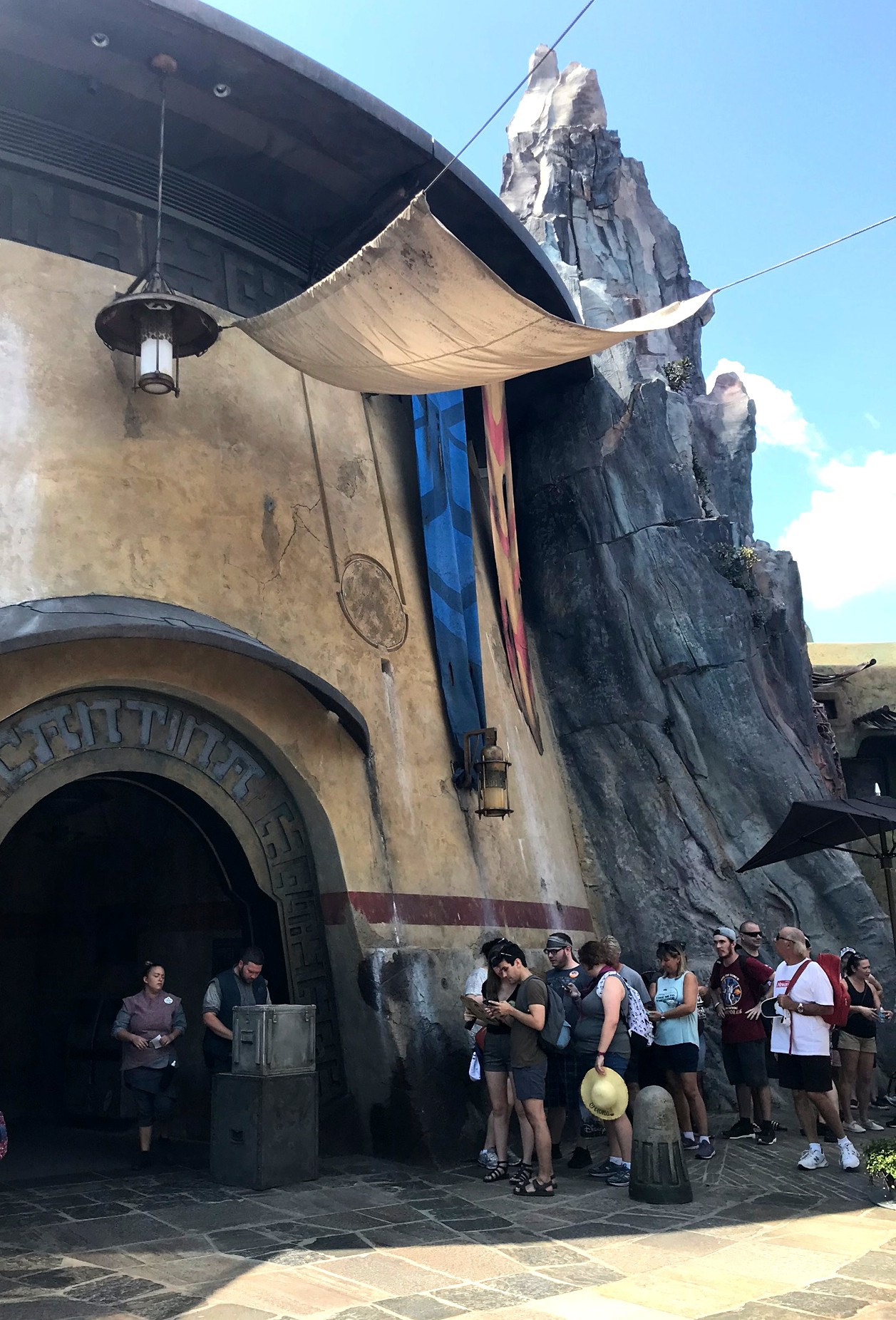 outside of Oga's Cantina with a line waiting to get in