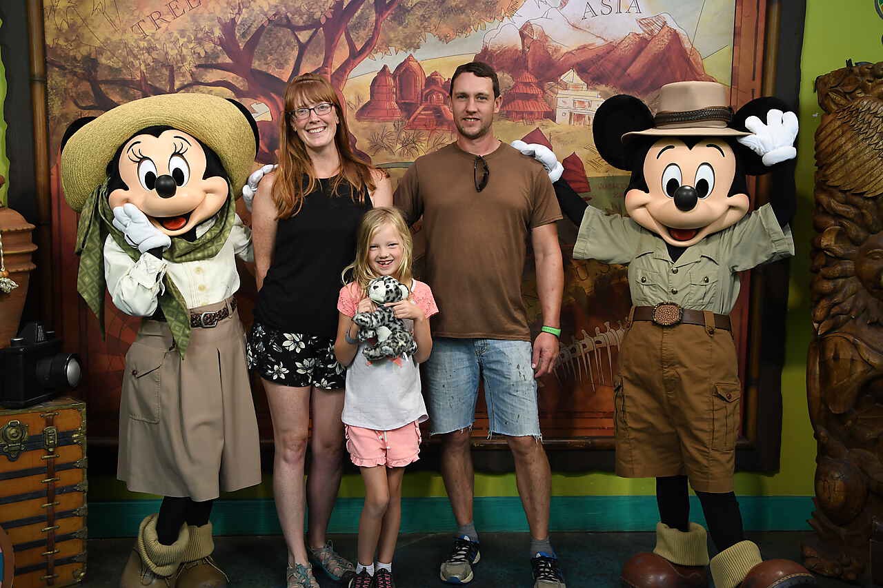 family posing with safari mickey and minnie disney characters
