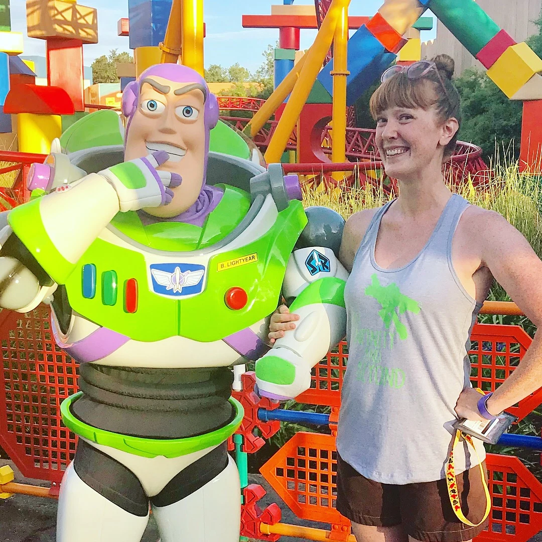 woman posing with disney character buzz lightyear