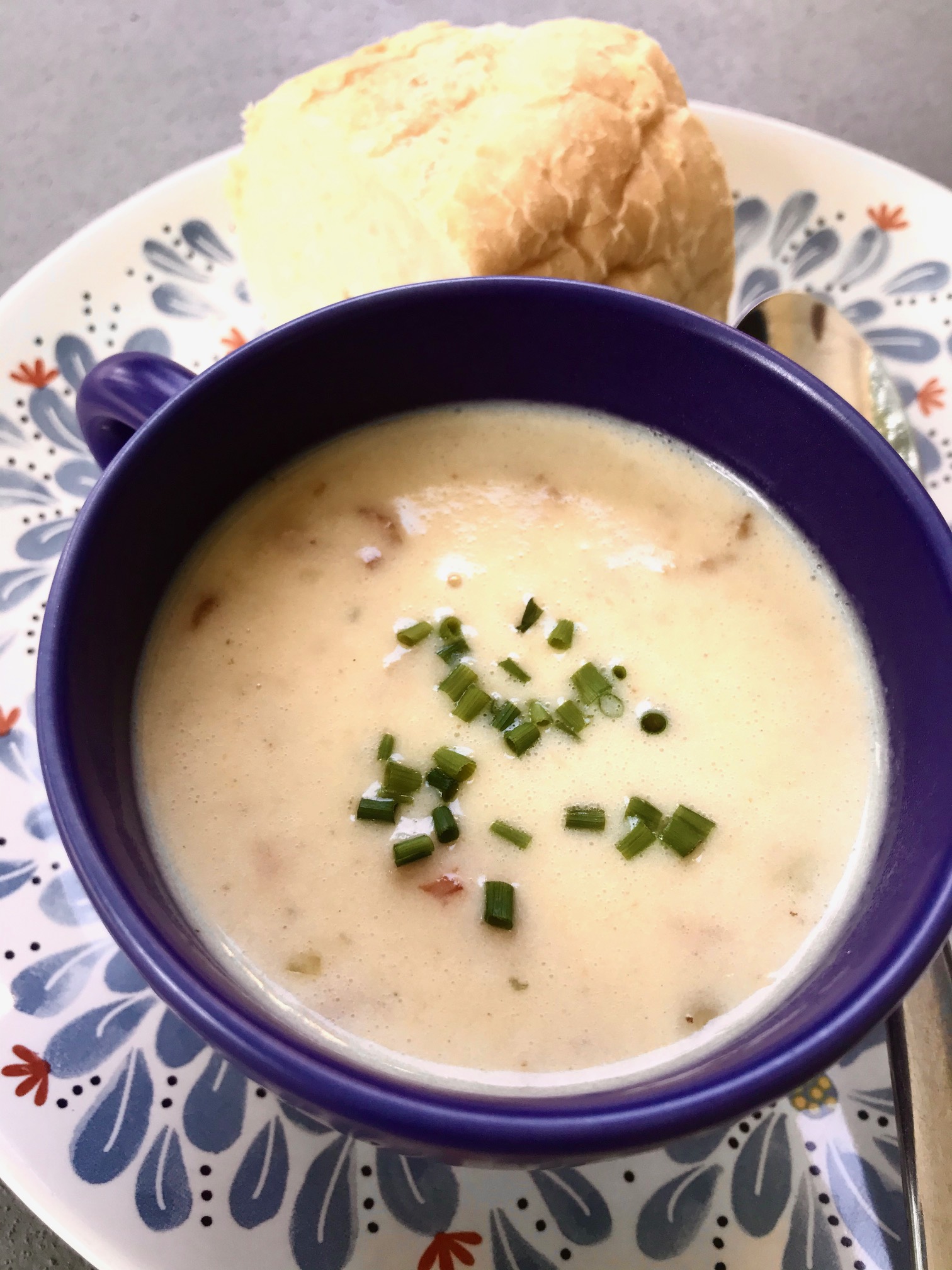 canadian cheese soup in a cup with french bread
