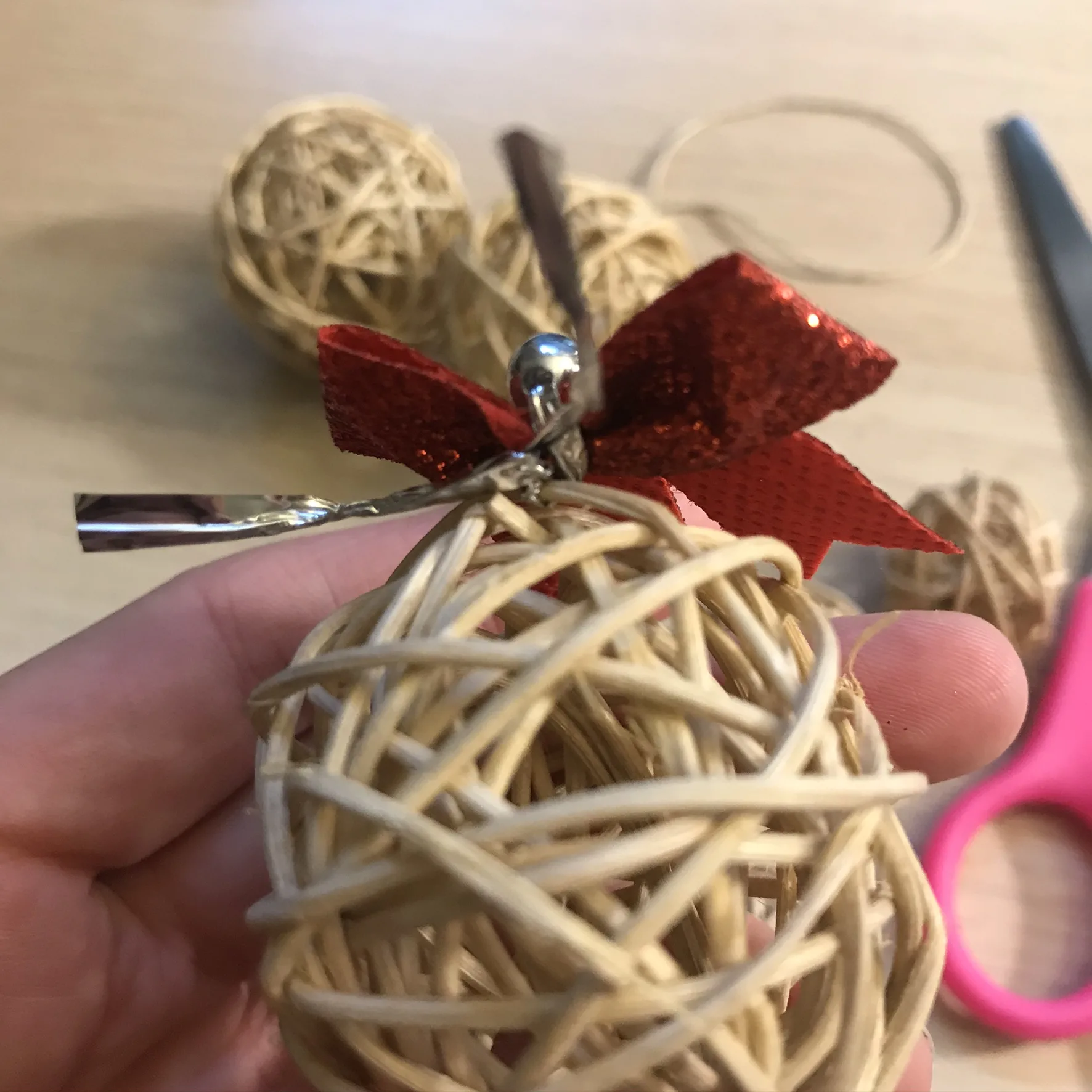 attaching bow to large willow ball with twist tie